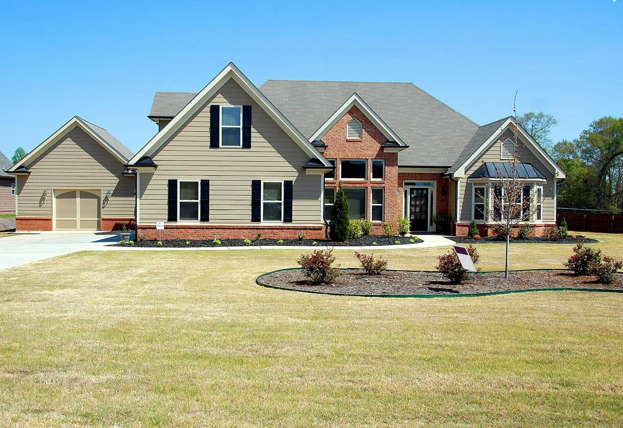 A large house with a lush green lawn in front of it